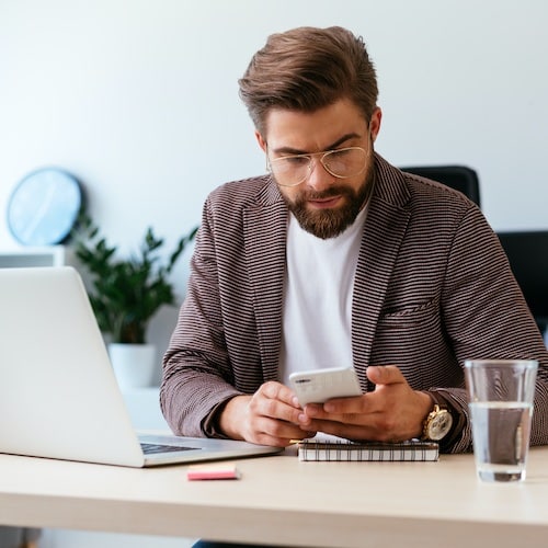 Businessperson checking social media while working from home by marketing refresh in houston, texas