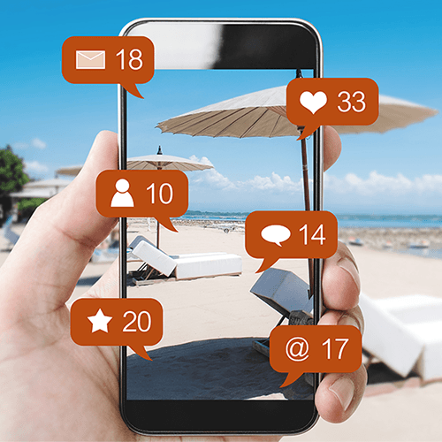 Professional Checking Phone On The Beach To See The Results Of Summer Marketing