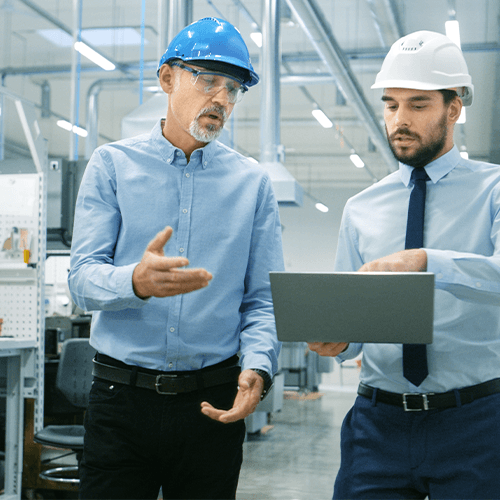 Manufacturing personnel review business performance on a tablet