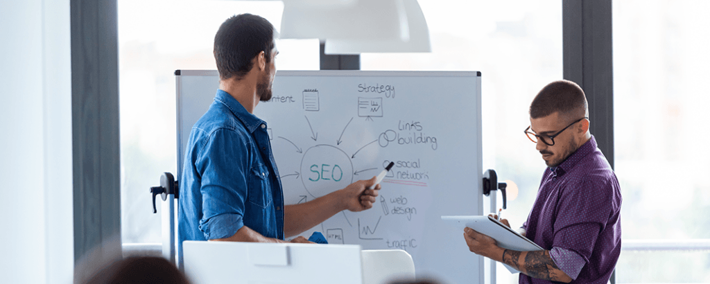 Marketing experts discussing SEO strategies with a B2B industrial company
