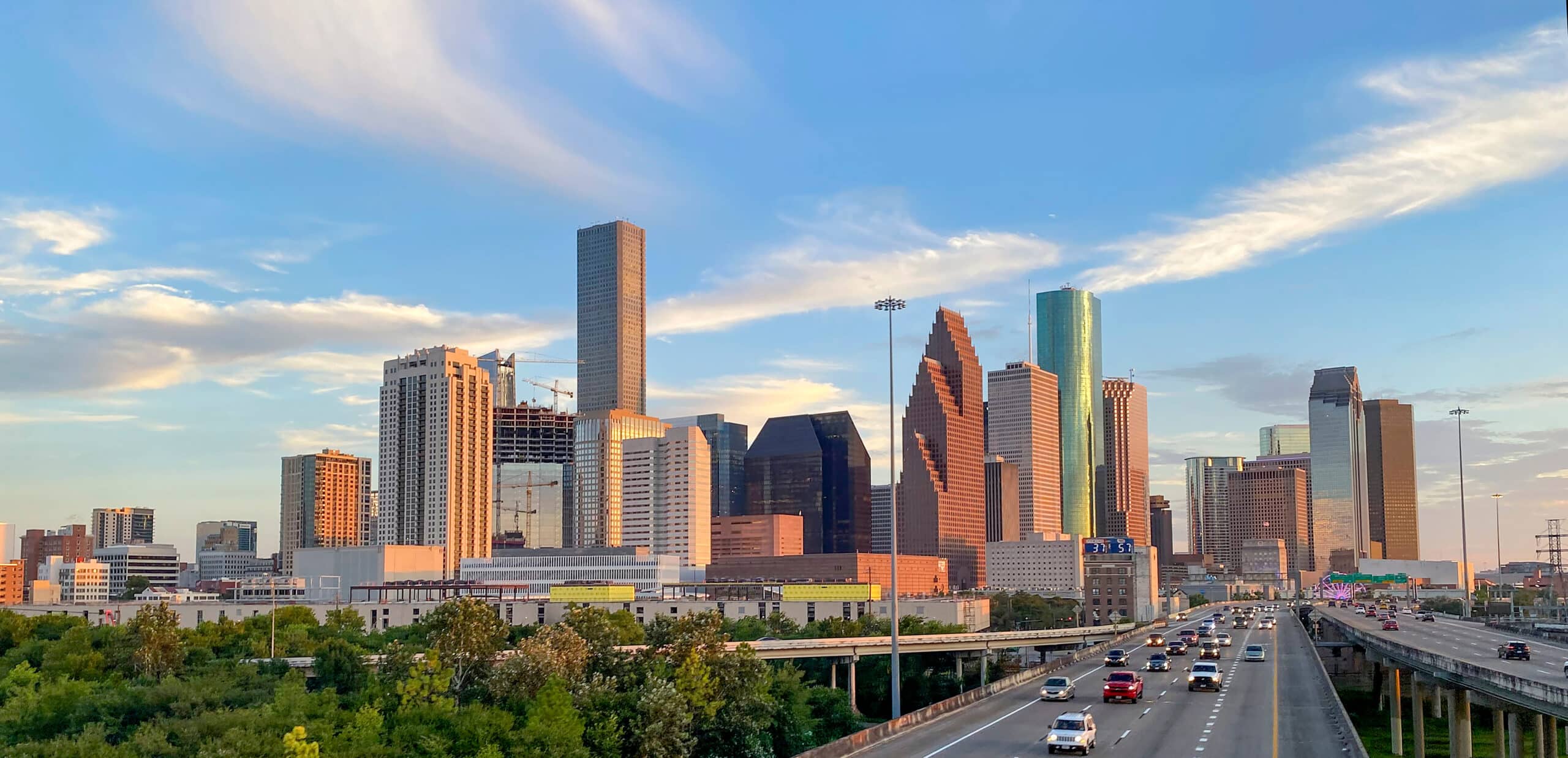 Aerial view of Downtown Houston, Texas behind a major freeway