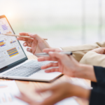 Marketing teams reviewing key metrics on a laptop screen