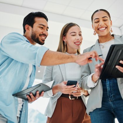 Business People, Teamwork And Collaboration On Tablet For Data Analytics, Marketing Results And Comparison In Office. Professional Group Of Women And Man For Digital, Social Media Or Startup Project.